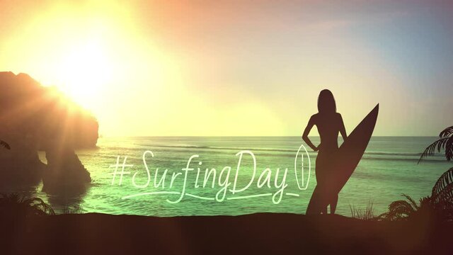 Silhouette of a girl with a surfboard on a sunset background.