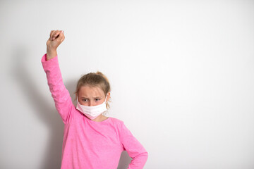 Young Girls with face masks on a white background with room for text or whitespace. Sisters acting silly. Kids with facemasks. 