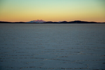 Uyuni Salt Flat Hexagonal Shaped Tiles Spreading Far Away at the Horizon at Sunrise with Volcanos...