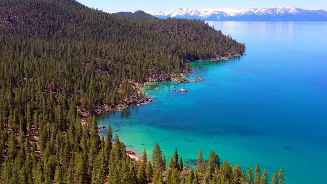Lake Tahoe California - Aerial Footage of Beautiful Tropical Clear Blue Turquoise Waters with Mountains in Background
