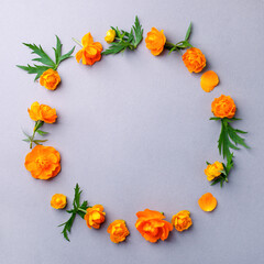 Orange Flowers composition. Wreath made of various fresh flowers on gray background. Spring, summer, woman, mother day, easter concept. Flat lay, top view, copy space