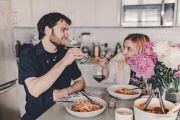 Family dinner. Pasta dinner with family. Delicious food and wine. Discussing the say during dinner. Laughing, talking. Gathering with food. Home cooking. Stay home and cook. Eat, drink, laugh.