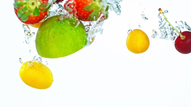 Super Slow Motion Shot of Fresh Fruits with Splashing Water Isolated on White Background. Filmed on high speed cinema camera at 1000fps.