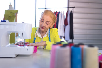 senior woman designer Sewing clothes with sewing machine