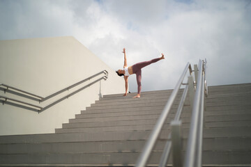 Street Yoga - Asian Chinese Woman doing yoga in public spaces