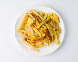 Appetizing fried potatoes on a white plate. Top view