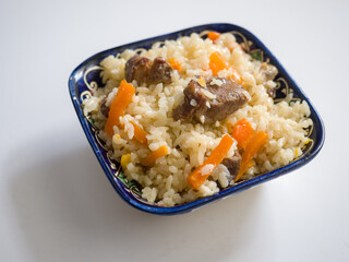 Pilaf in a national oriental bowl. Asian traditional dish
