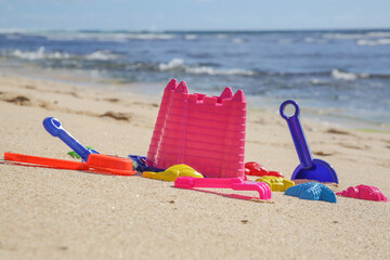 Plastic children toys on the sand beach.