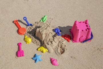 Fototapeta na wymiar Plastic children toys on the sand beach.