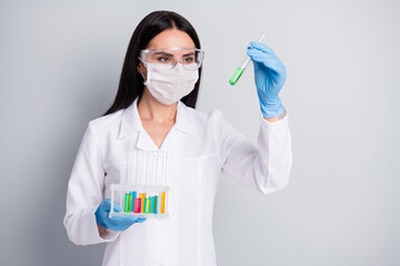 Close-up portrait of her she nice attractive girl biologist scientist doc holding in hands flasks...