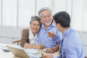 Happy retired Asian senior eldery couple consult with personal financial advisor or real estate...