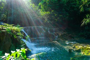 Kuangsi Waterfall, lower level. The mist, the sunlight, and the camera have caught the rainbow colours in the beautiful photo of the lower falls in Luang Prabang, Laos.