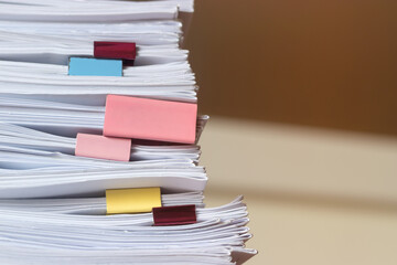 Pile of student homework that assigned to student to be completed outside class on teacher desk...