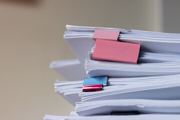 Pile of student homework that assigned to student to be completed outside class on teacher desk...