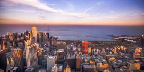 Aerial View of the Architecture and Buildings of the Skyline of Chicago overlooking the Sunset on Lake Michigan