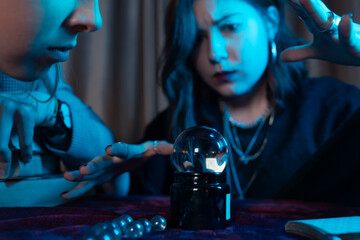 Woman and woman fortune teller with crystal ball