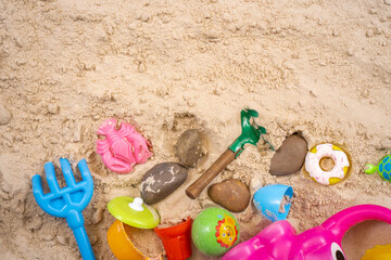 Fototapeta na wymiar Beach toys on sand background.