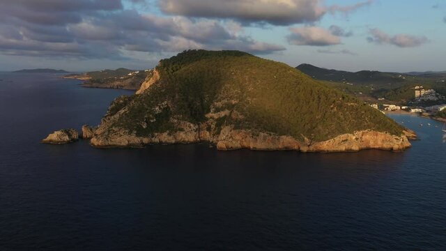 Aerial view of Cala Llonga beach, located in southern Ibiza, Spain. Beautiful aerial view of the bay at sunset
