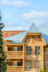 A perfect neighborhood. Houses in suburb at Summer in the north America. Top of a luxury house with nice window over blue sky.