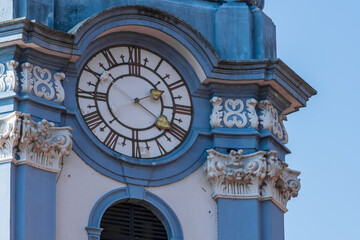 Clock from a blue church detail view with blue sky