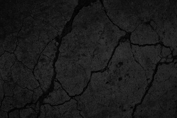 Black grunge background. Texture of cracked concrete wall. Close-up. Background with old dirty...