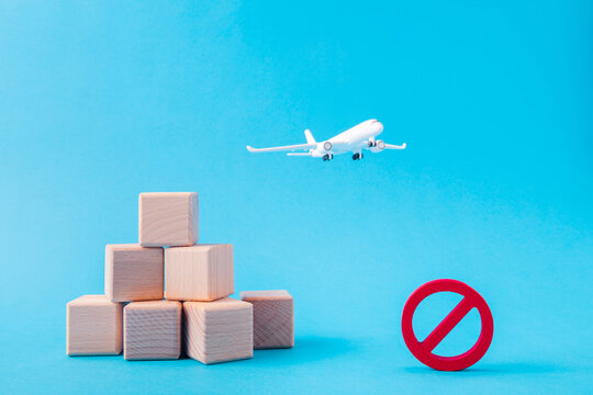 Picture of nice white aircraft plane flying pile stack cubes carrying abroad taxes payment expenses prohibition sign isolated over bright vivid shine vibrant blue color background