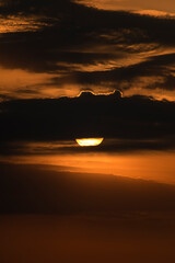 Dramatic Sunrise with the sun behind the clouds 