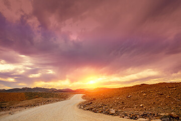 Mountain desert landscape during blazing sunset. National Park Makhtesh Ramon Crater in Negev desert, Israel