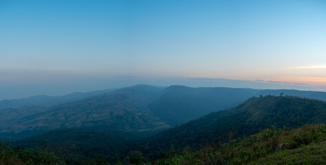 Fototapeta premium Phu Lom Lo mountains and valley, panoramic view, evening light with fog.