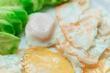 yellow and white fried eggs with green cucumber slices