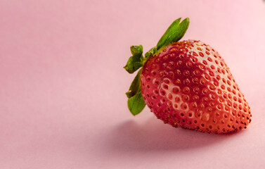 Red fresh strawberries on a pink background, place for text, the concept of healthy eating, organic, health, vitamins