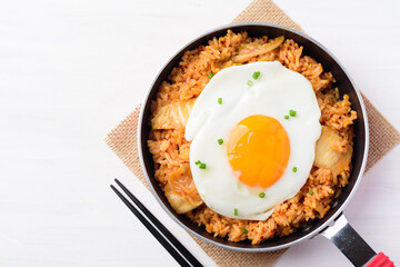 Kimchi fried rice with fried egg in cooking pand and chopsticks, Korean food