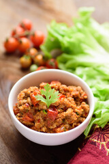 Northern Thai food (Nam Prik Ong), spicy chili minced pork with tomatoes in a bowl