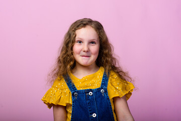 Happy carefree child emotions. Energetic joyful adorable little girl laughing at joke on pink background.