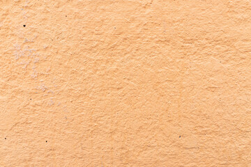 Orange rough stucco on the wall