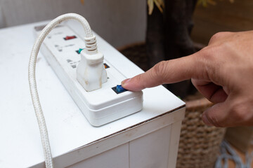 hand turn off the electricity plug socket to save energy when not use