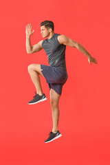 Sporty jumping man on color background