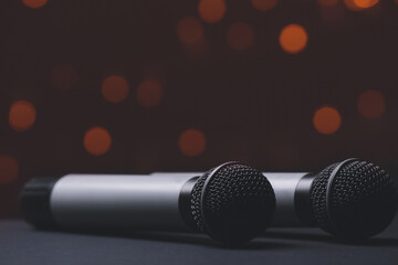 Obraz premium Two Professional Microphones with Warm Bokeh Lights