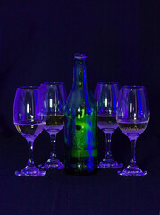
glasses with wine bottle on black background