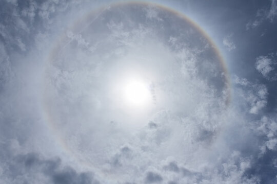 Sun halo phenomenon, circular rainbow around the sun.