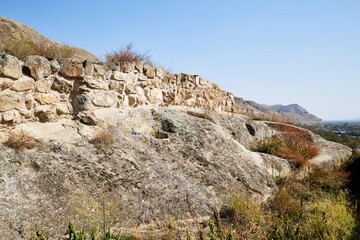 Rocks, stones, stone in the mountain reserve and blue sky on a summer day. Uplistsikhe city in Georgia, Europe