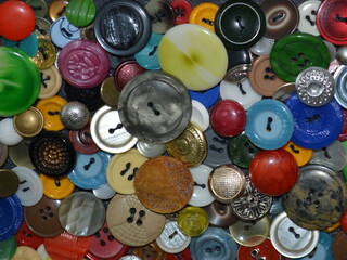 Close up of a panel of multicolored buttons sewn on the fabric