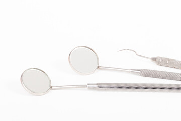 dental tool mirror and hook on white background