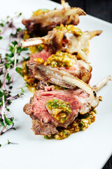 Closeup on gourmet fried lamb chops with sauce 