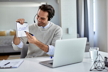 Young teacher giving classes online from home.