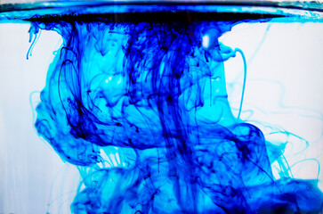The entry of blue color into the liquid. Visible surface from below and color movement