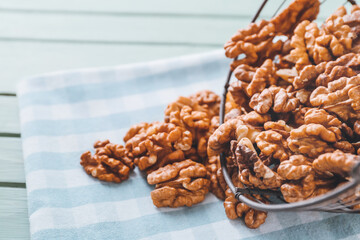 Basket and scattered walnuts on table