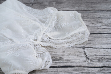 The lace white  women underwear on wooden background. Top view. Flat lay.
