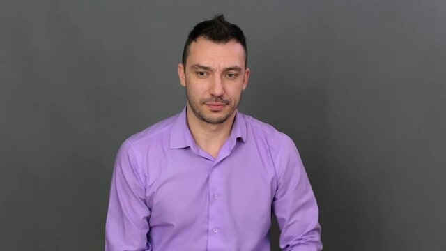 Closeup young man shows timidity. He shows emotions professionally. Soft light. High quality FullHD frames.