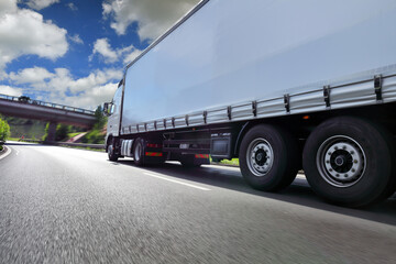 Naklejka na ściany i meble Truck transport on the road and cargo